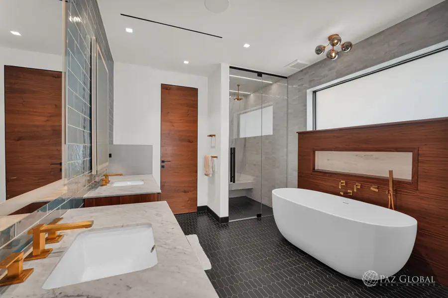 Primary bath with freestanding tub and walnut vanity