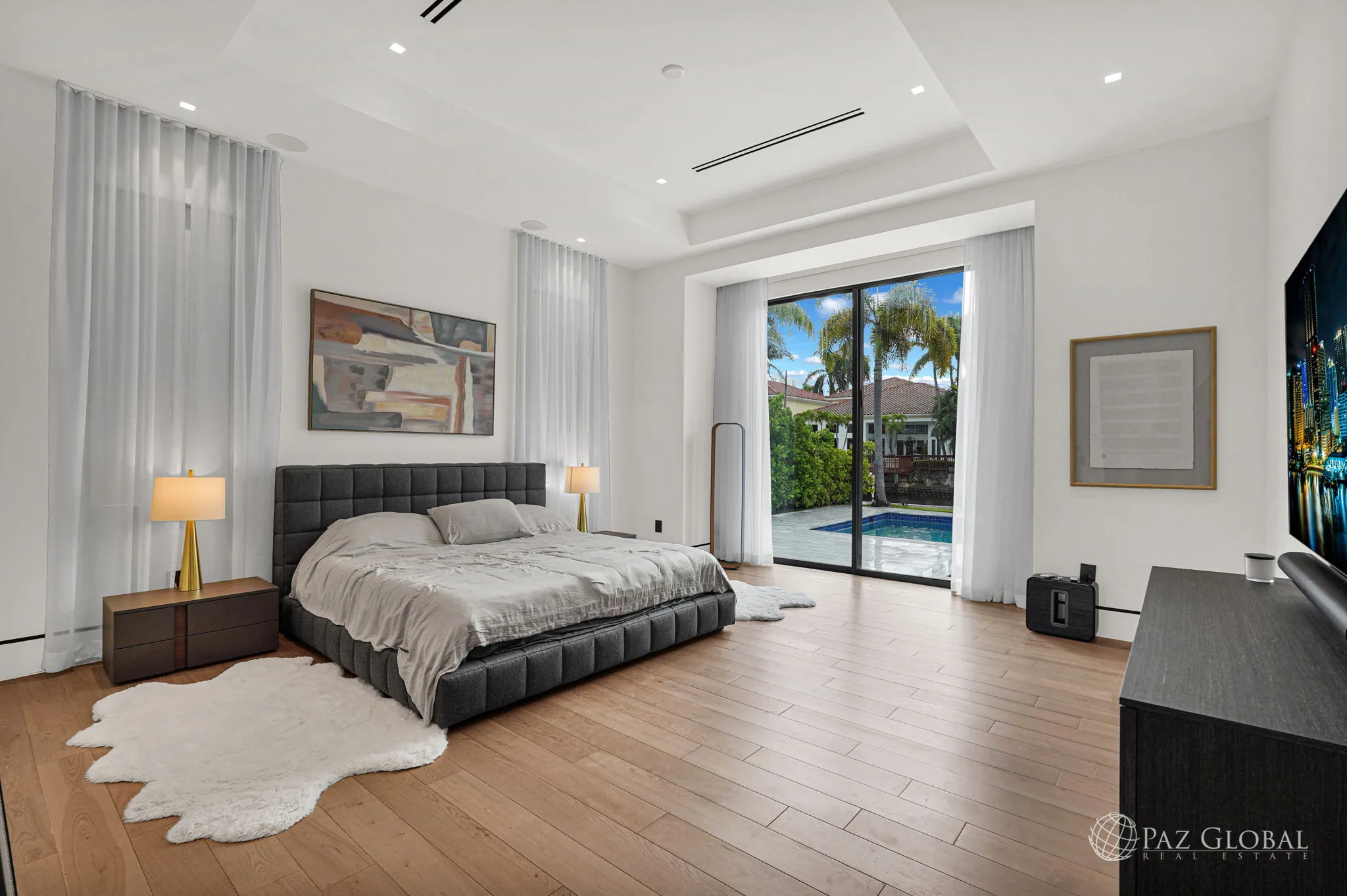 Primary bedroom with sliding doors to the pool deck